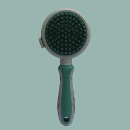 Green and pink two-sided pet brush showing retractable slicker bristles and silicone massage nubs on a white background.