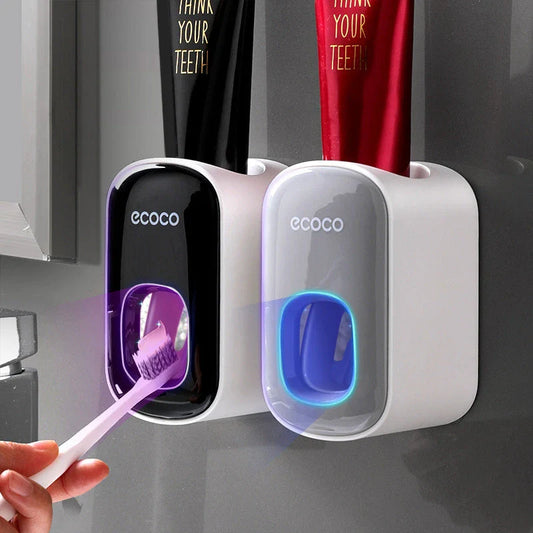 Wall-mounted automatic toothpaste dispenser with toothbrush holder and storage organizer, available in black and grey colors