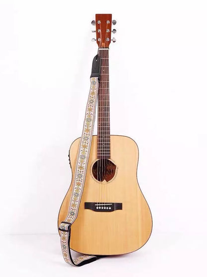Adjustable embroidered guitar strap with durable webbing and intricate design