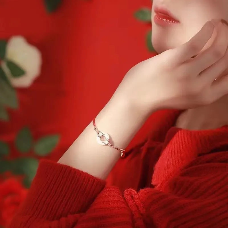 Women's festive koi bracelet with peace buckle in red rope design showing fishtail details