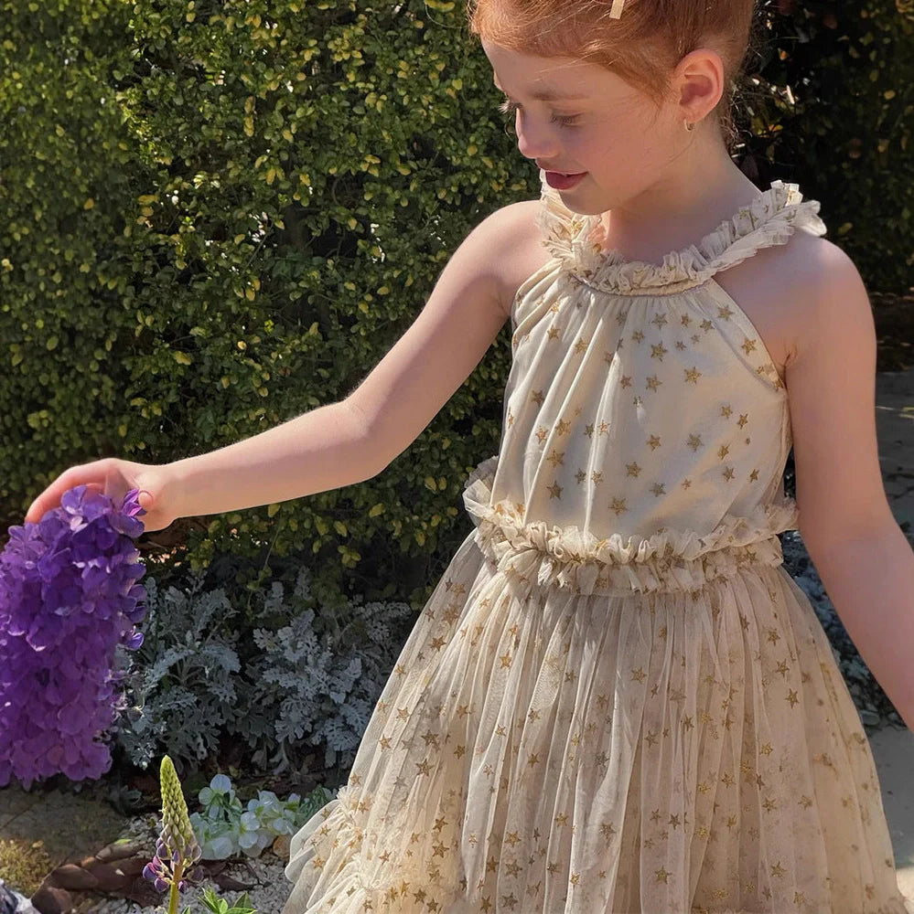 Apricot-coloured girls' halter neck tulle skirt with sleeveless design and floaty appearance