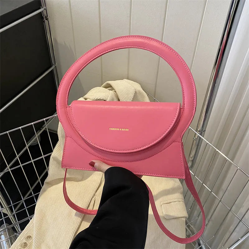 Simple square messenger bag in PU leather with a shoulder strap, shown in various colours.