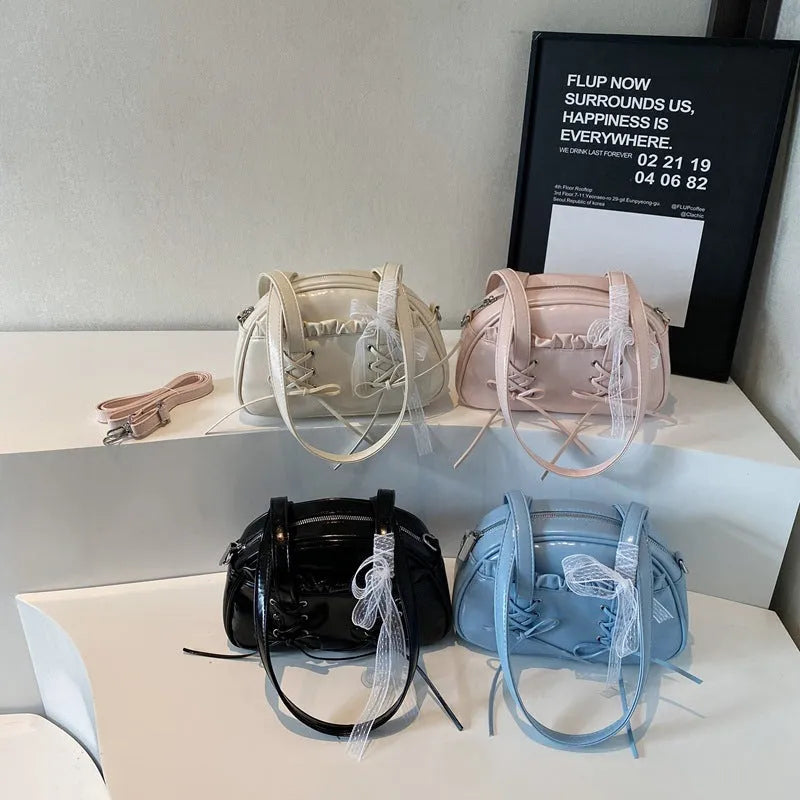 Milky white women's shoulder handbag with a large bandage bow and visible stitching, showing the internal phone pocket.