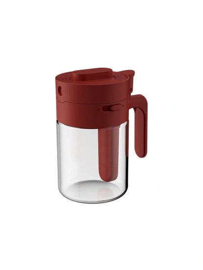 Small glass seasoning jars with lids and spoons in various colors for kitchen organization