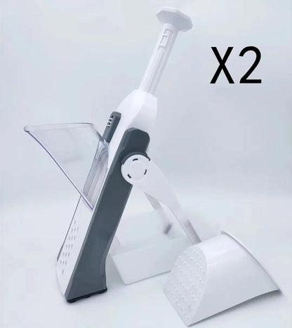 White and blue multifunctional vegetable slicer with stainless steel blades on a kitchen counter.