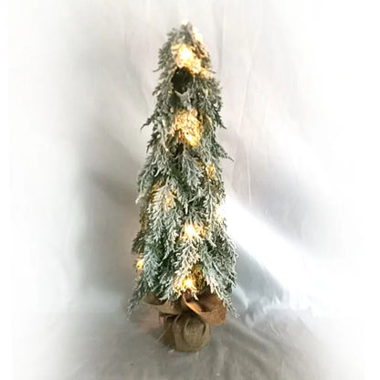 Compact 24-inch white pre-lit artificial Christmas tree with snow-covered branches on a table.