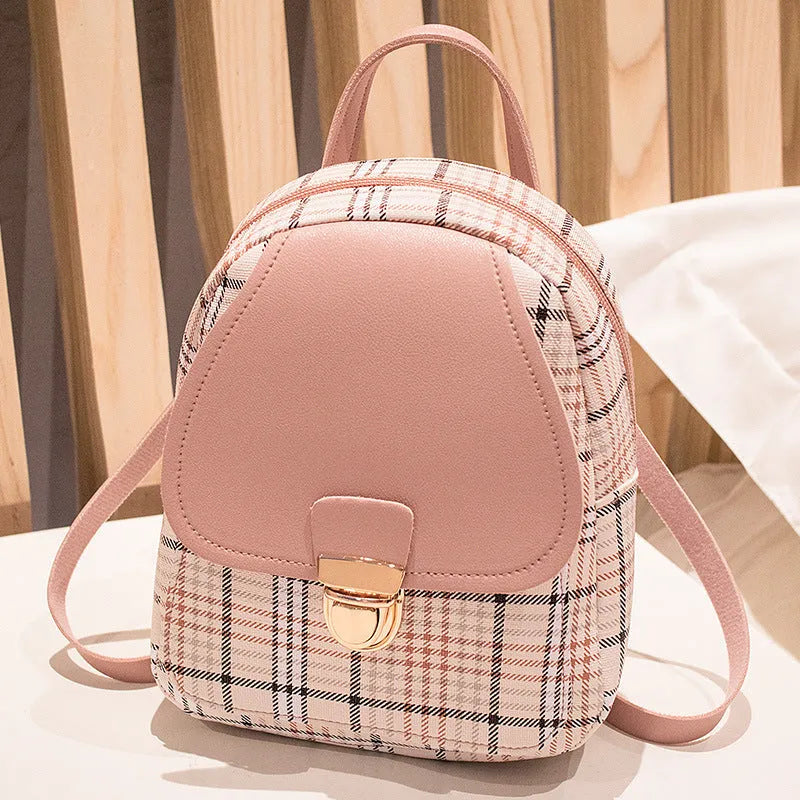 A women's black one shoulder diagonal phone bag made from PU leather, shown being worn cross-body.
