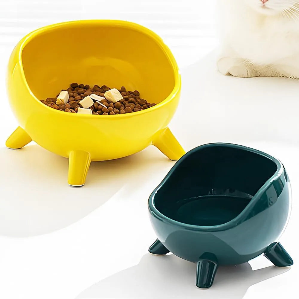 Green ceramic cat food bowl with four legs and elevated design for stable feeding