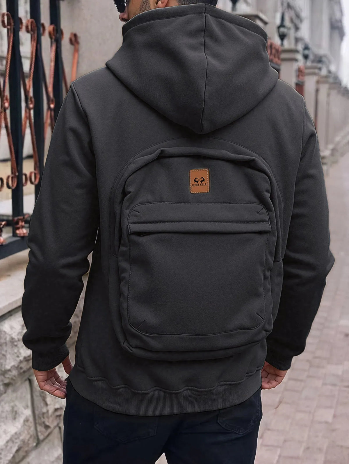 Men's loose-fit hoodie cardigan sweater with back schoolbag design and stick pocket in light grey, black and blue.