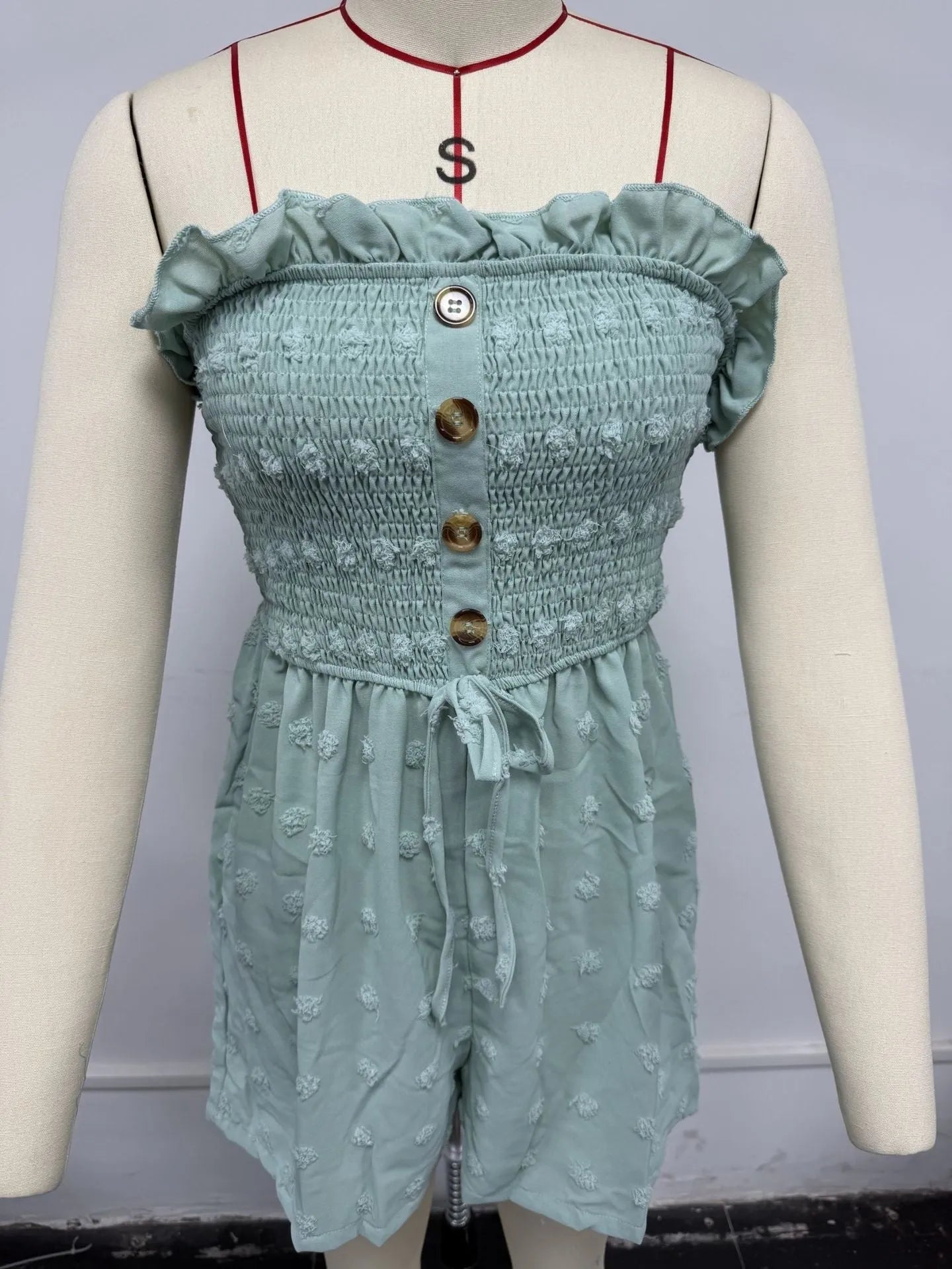 Women's off-shoulder sleeveless jumpsuit in polyester fabric with button detailing and mid-waist design