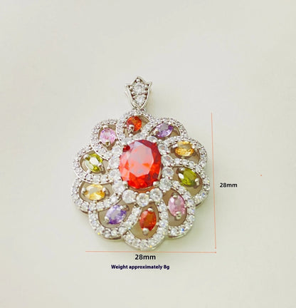 Close-up of a women's gold-coloured flower pendant necklace with a bright zircon stone centre.