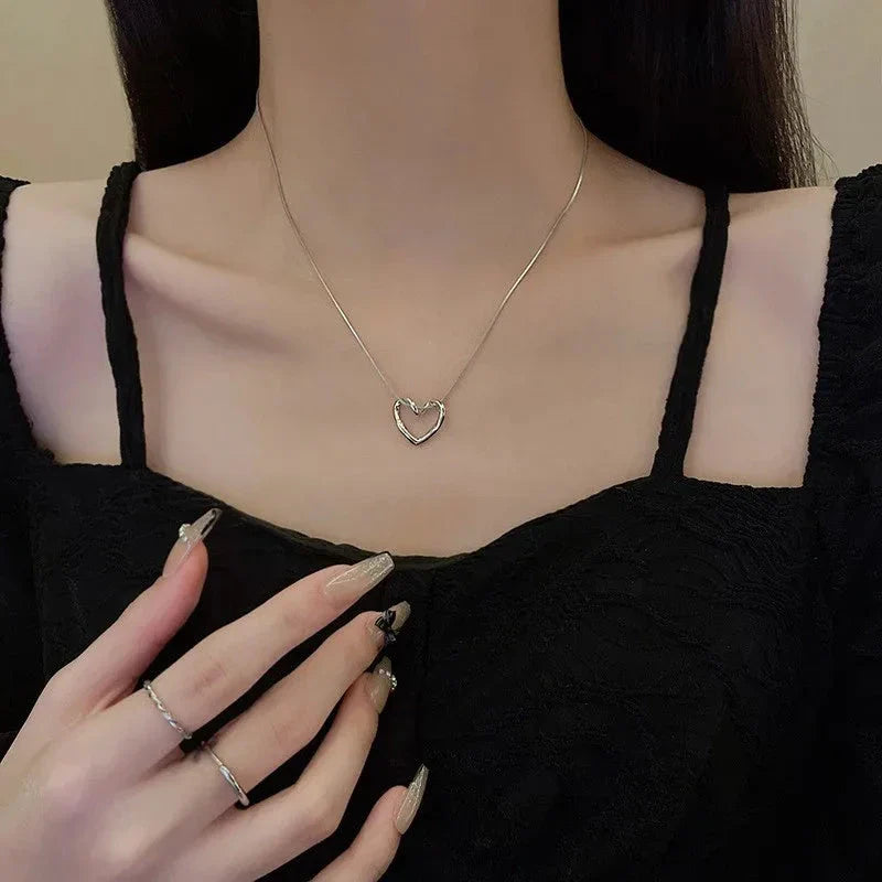 Stylish titanium steel heart pendant necklace with unique twist design, available in gold and silver colors