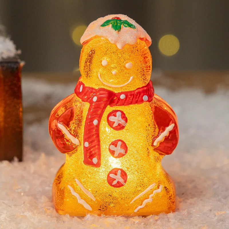 Glowing gingerbread man Christmas ornament measuring 6.5cm wide with LED lights and red scarf
