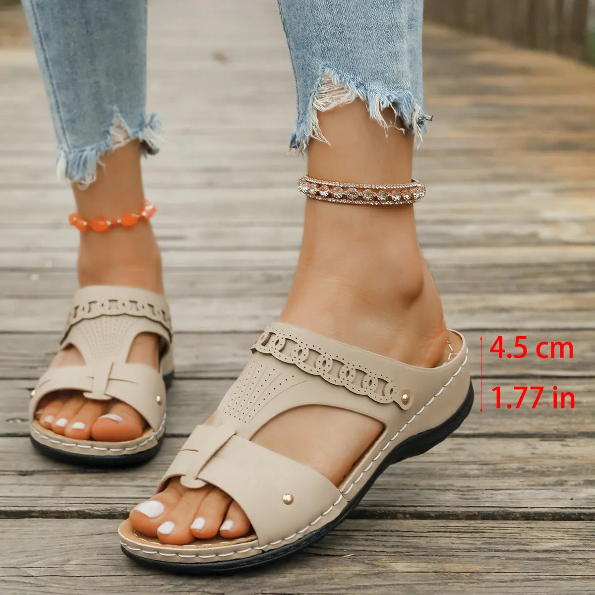 Blue roman style slippers with a slope heel and fish mouth toe holder on a wooden floor.