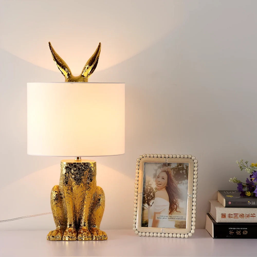 White rabbit table lamp with metal base and resin details, 24cm wide by 49cm high