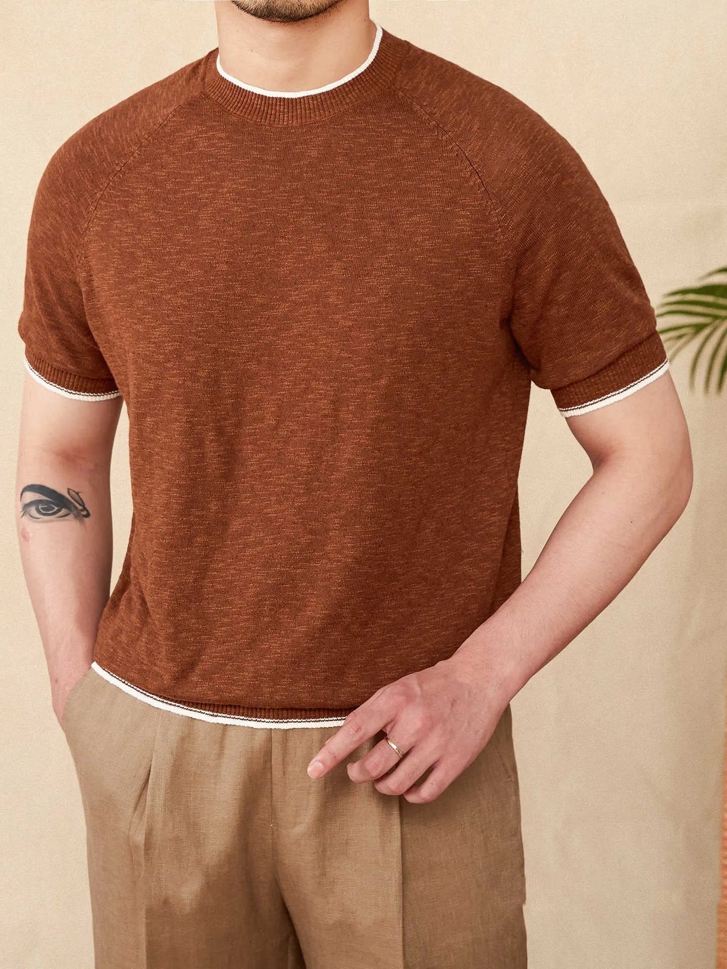 Brown linen-cotton blend short sleeve t-shirt with round neck on a hanger.