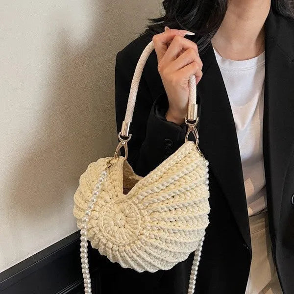 Handmade woven cloth bag with double shoulder straps in shell shape showing open pocket design