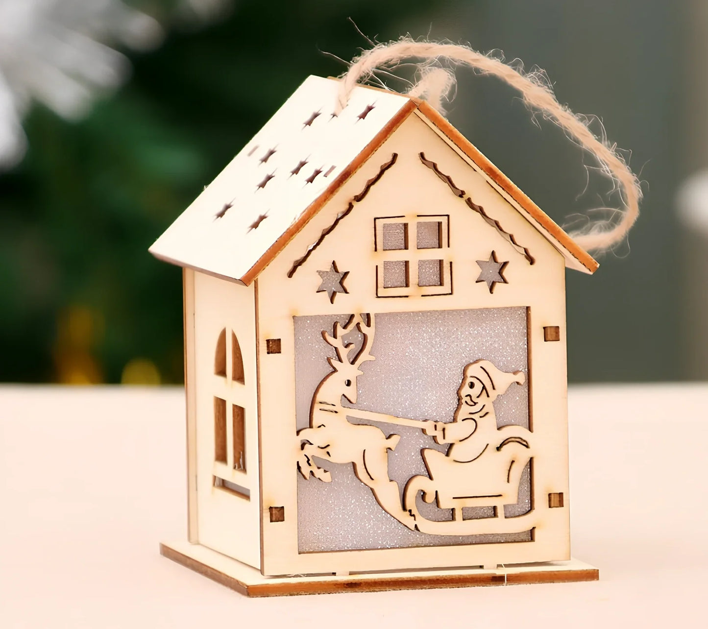 Wooden Christmas decorations with LED lights showing four character styles hanging on tree branches