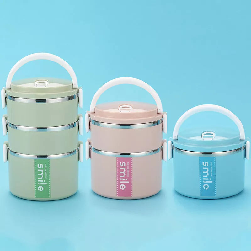 Stainless steel lunch box with built-in spoon, leak-proof design, available in green, pink, and blue