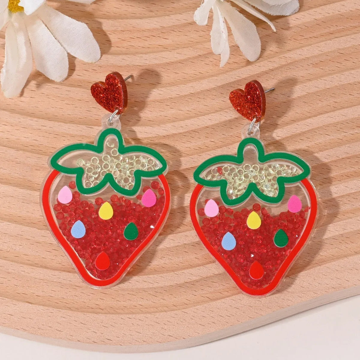 Colourful acrylic earrings with fruit and dessert designs including cherry, strawberry, watermelon, pineapple, coconut, cake and ice cream motifs