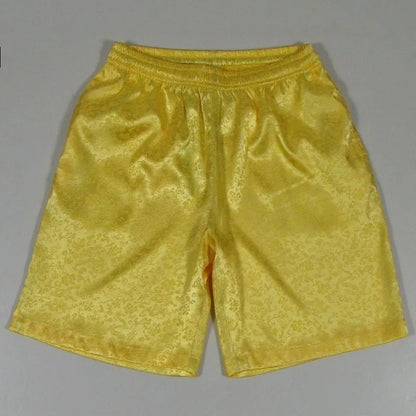 Men's black Tai Chi shorts with a white drawstring elastic waistband laid flat.