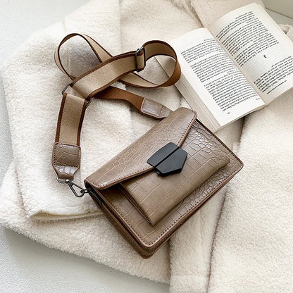 Vintage crossbody bag in black showing 20cm width, crossbody strap, and front storage compartment
