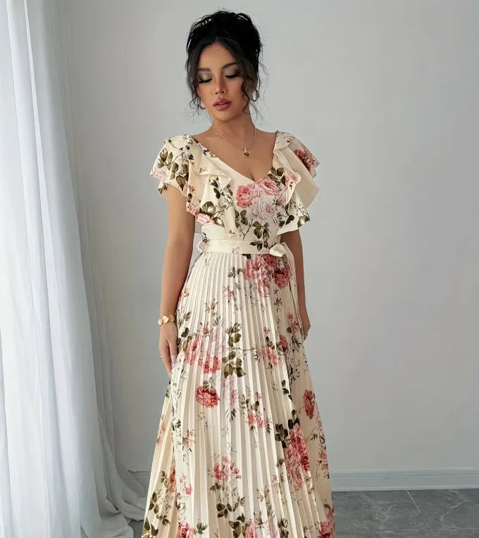 Apricot-coloured V-neck dress with floral print, ruffled short sleeves, high waist, and a long, pleated swing skirt.