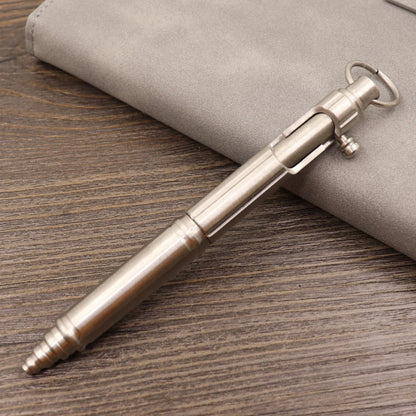 Brass tactical pen with press bolt mechanism showing cylindrical design and six ring details
