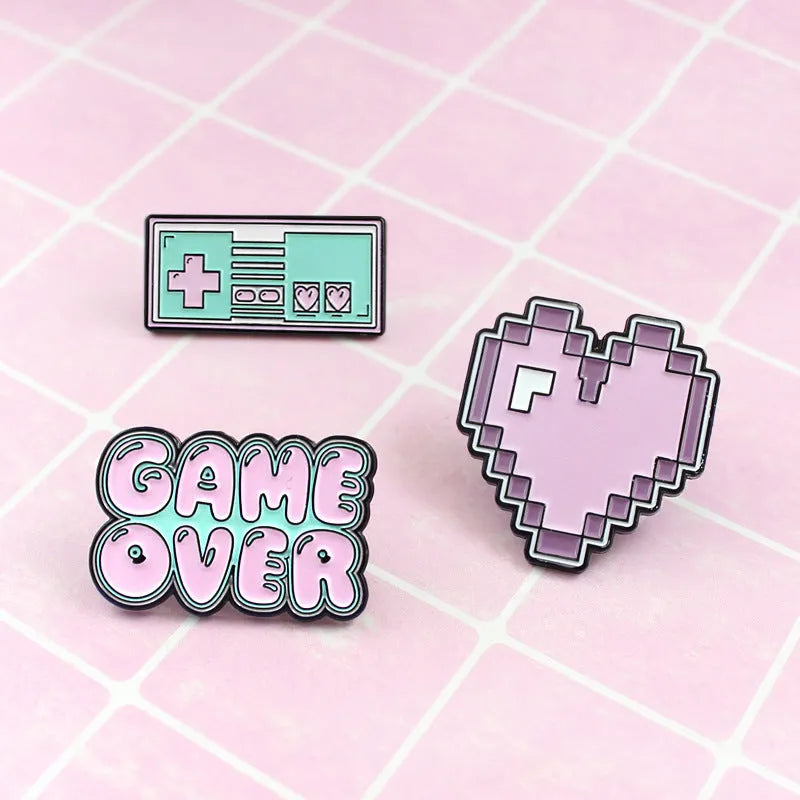 Stereo game console badge made from alloy metal in three colour options for bag mounting.