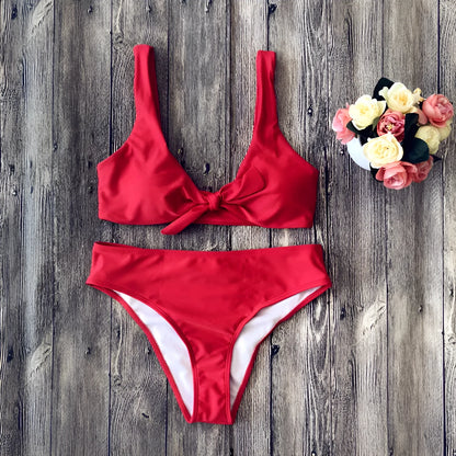 Women's solid colour bikini set with triangle bra and high-cut briefs on a neutral background.