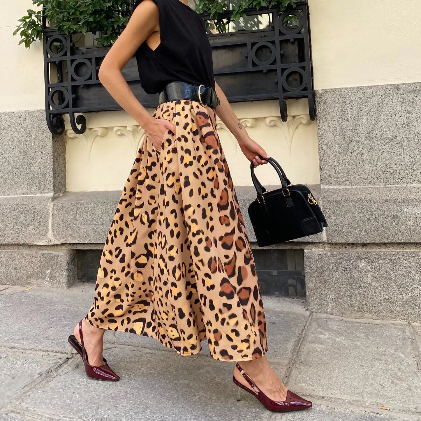 Brown leopard print A-line long skirt with 120cm hem, made from 100% polyester fabric, shown in sizes S to XL.