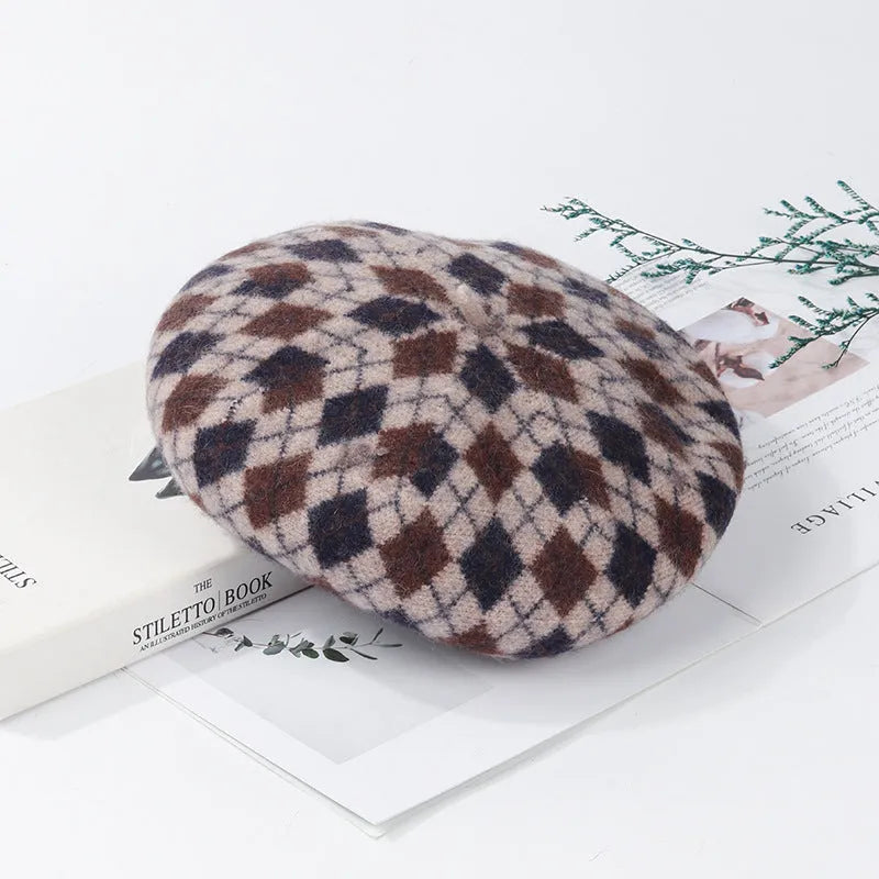 Wool plaid beret with dome crown, adjustable size, and tassel and mesh detail in blue light coffee plaid.