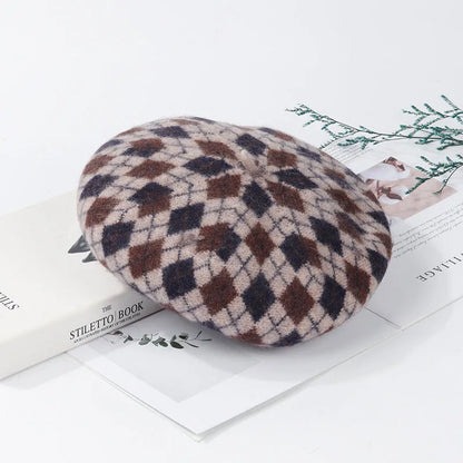Wool plaid beret with dome crown, adjustable size, and tassel and mesh detail in blue light coffee plaid.