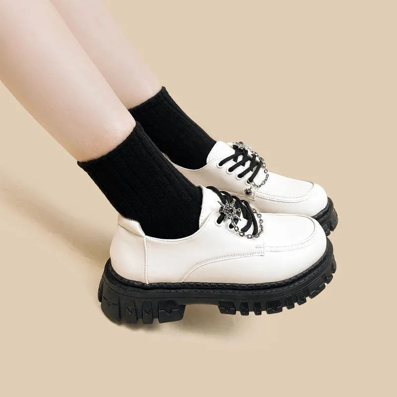 Women's Duke Asterism preppy loafers with a round toe and metal cross shoulder strap.