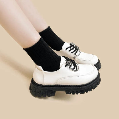 Women's Duke Asterism preppy loafers with a round toe and metal cross shoulder strap.