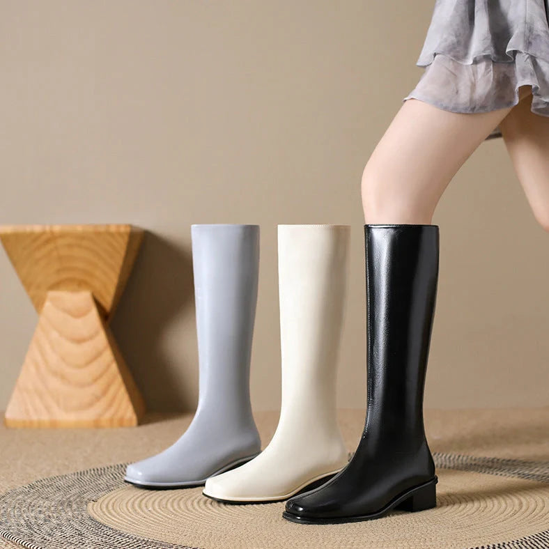 Black square toe over-the-knee boots with 4cm chunky heel showing leather interior and rubber sole