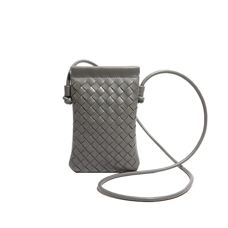 Vertical square vintage weave crossbody bag in multiple colours showing internal dark cell phone pocket.
