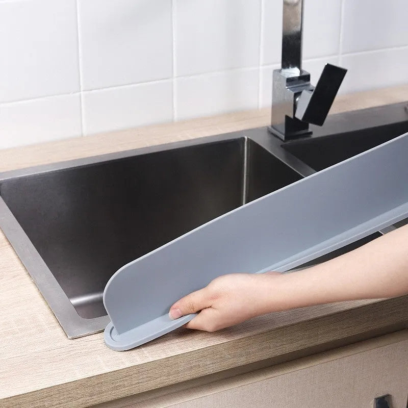 Grey silicone sink water blocking plate showing 52mm height and 85mm length dimensions