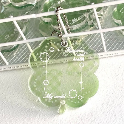 Blue, green, and mint green four-leaf clover acrylic pendant keychain on a metal ring.