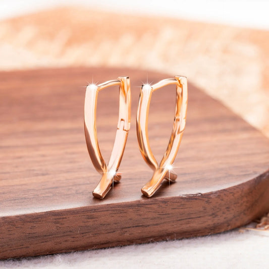 Cross-shaped copper earrings with rose gold finish, showing dimensions and post closure