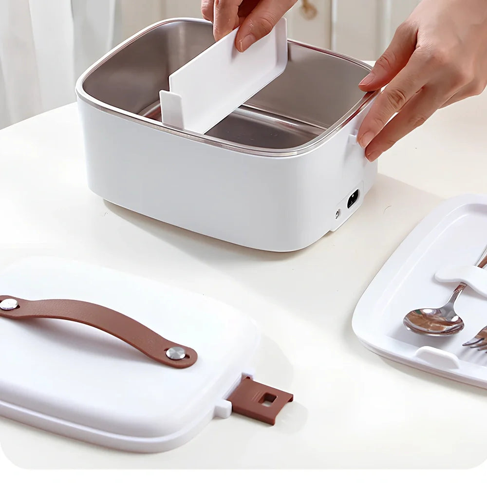 White car heating lunch box with stainless steel interior showing power cords and utensils