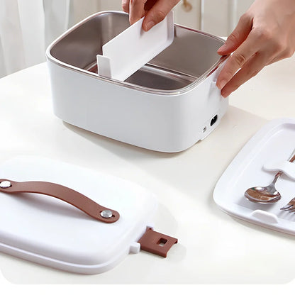 White car heating lunch box with stainless steel interior showing power cords and utensils