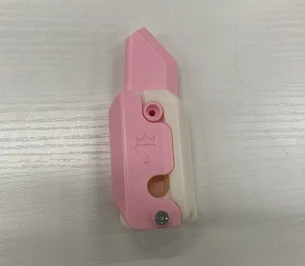 Small orange and green 3D printed plastic carrot knife fidget toy with blade extended.