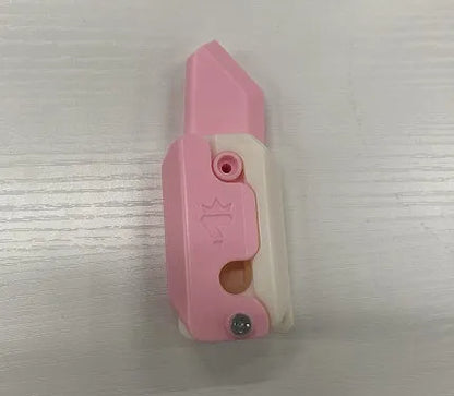 Small orange and green 3D printed plastic carrot knife fidget toy with blade extended.