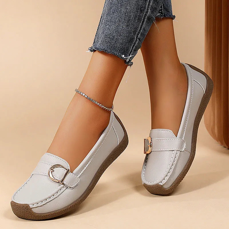 Women's beige casual loafers with round toe and flat heel on a white background.