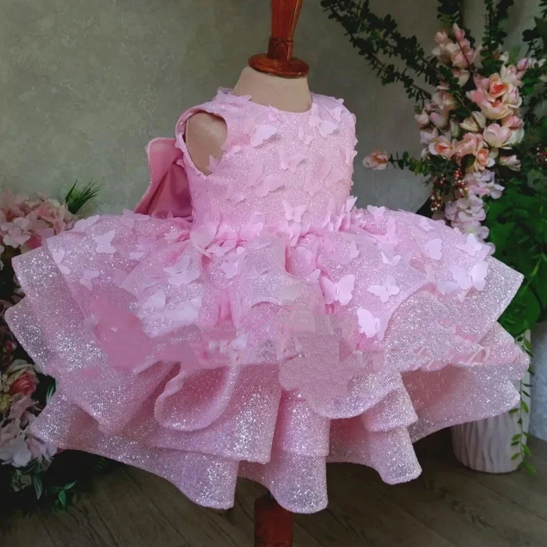 Pink sleeveless girls' dress with three-dimensional butterfly decoration on front