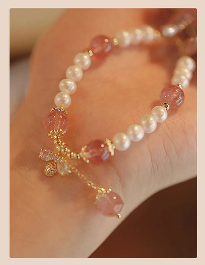 Women's adjustable Strawberry Quartz crystal bracelet with bow charm on wrist