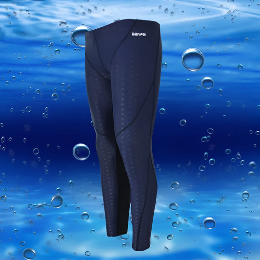Men's black and grey cropped nylon swimming trunks with mesh lining, laid flat.