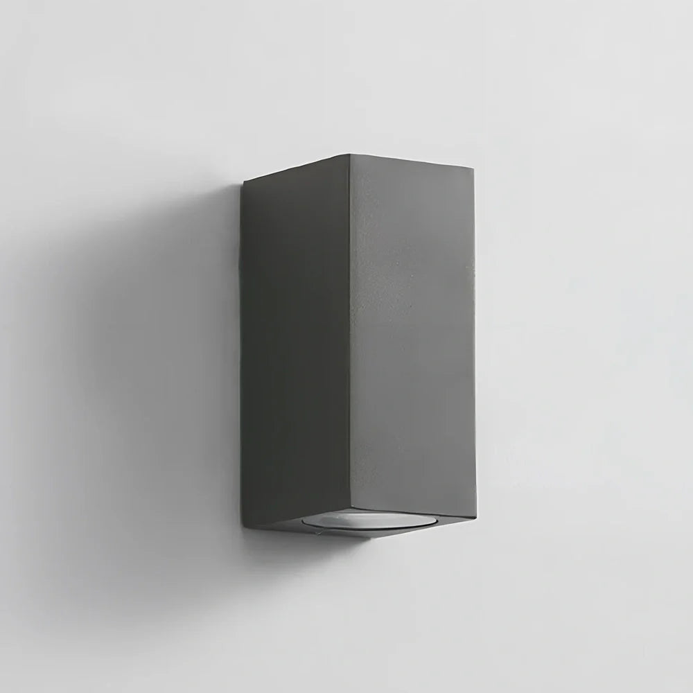 Black aluminium LED wall lamp with tempered glass shade mounted on white wall