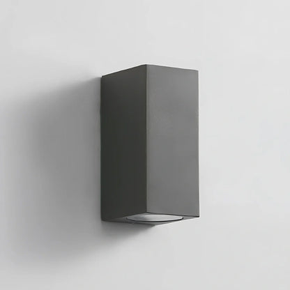 Black aluminium LED wall lamp with tempered glass shade mounted on white wall